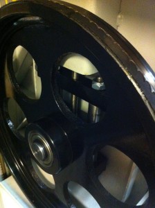 Massive iron wheel hides a sturdy tension mechanism