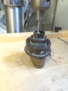 The drill press set up to remove the inner most tube on the Dewalt sander dust fitting